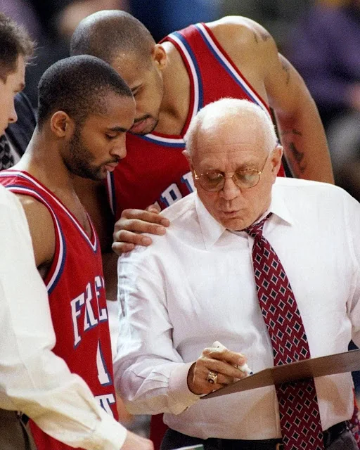 Coach Jerry Tarkanian with basketball players · 2