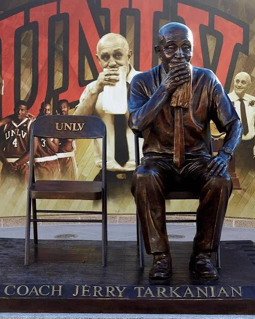Coach Jerry Tarkanian with basketball players · 3