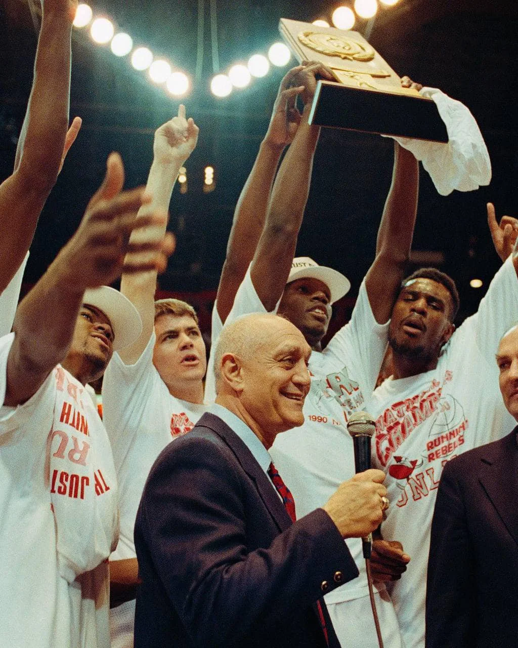 Coach Jerry Tarkanian with basketball players · 5
